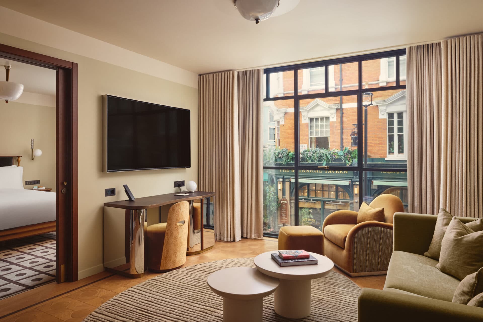 One-Bedroom Suite living room with curved sofa and arched windows
