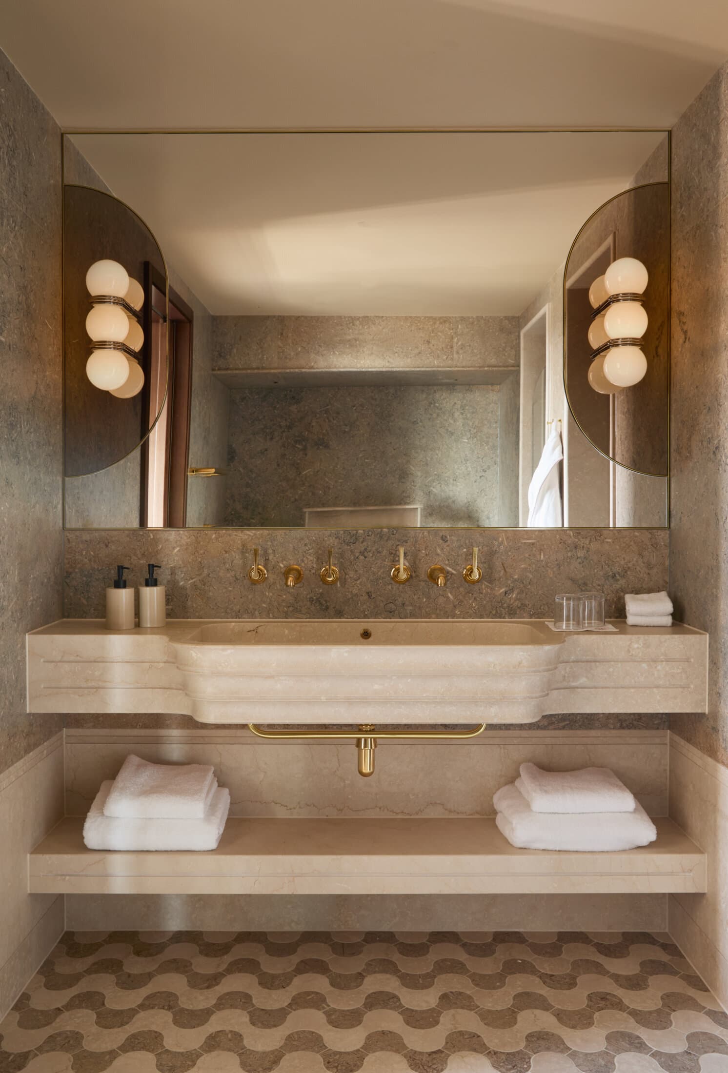 Travertine powder room with brass fittings