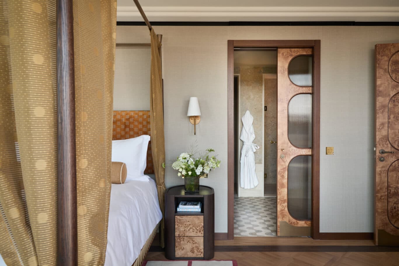 Penthouse bedroom with four-poster bed and golden drapes