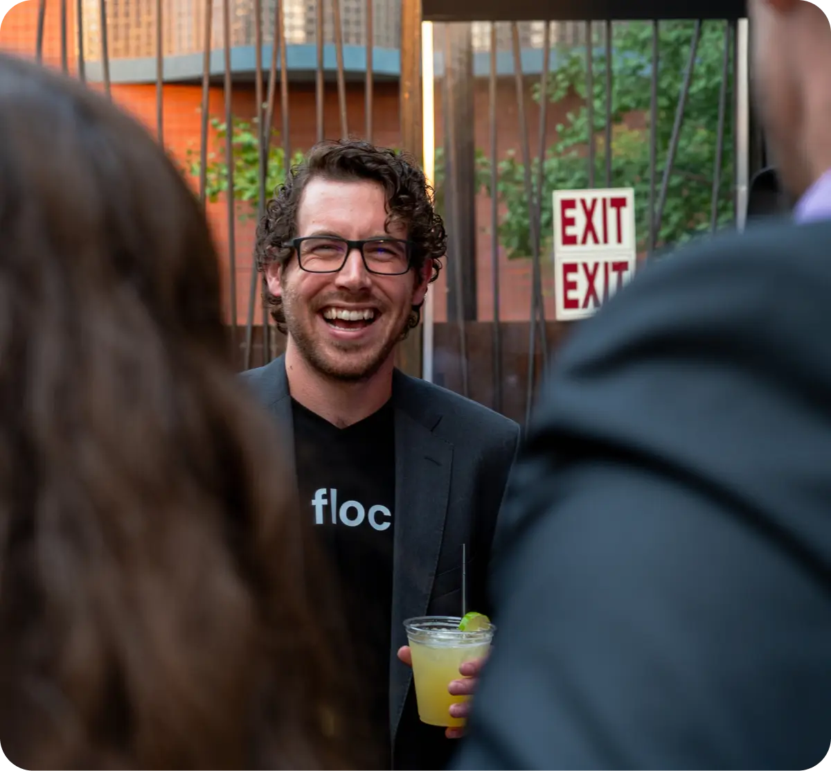 Devon Bleibtrey smiling and laughing while discussing generative AI with people.