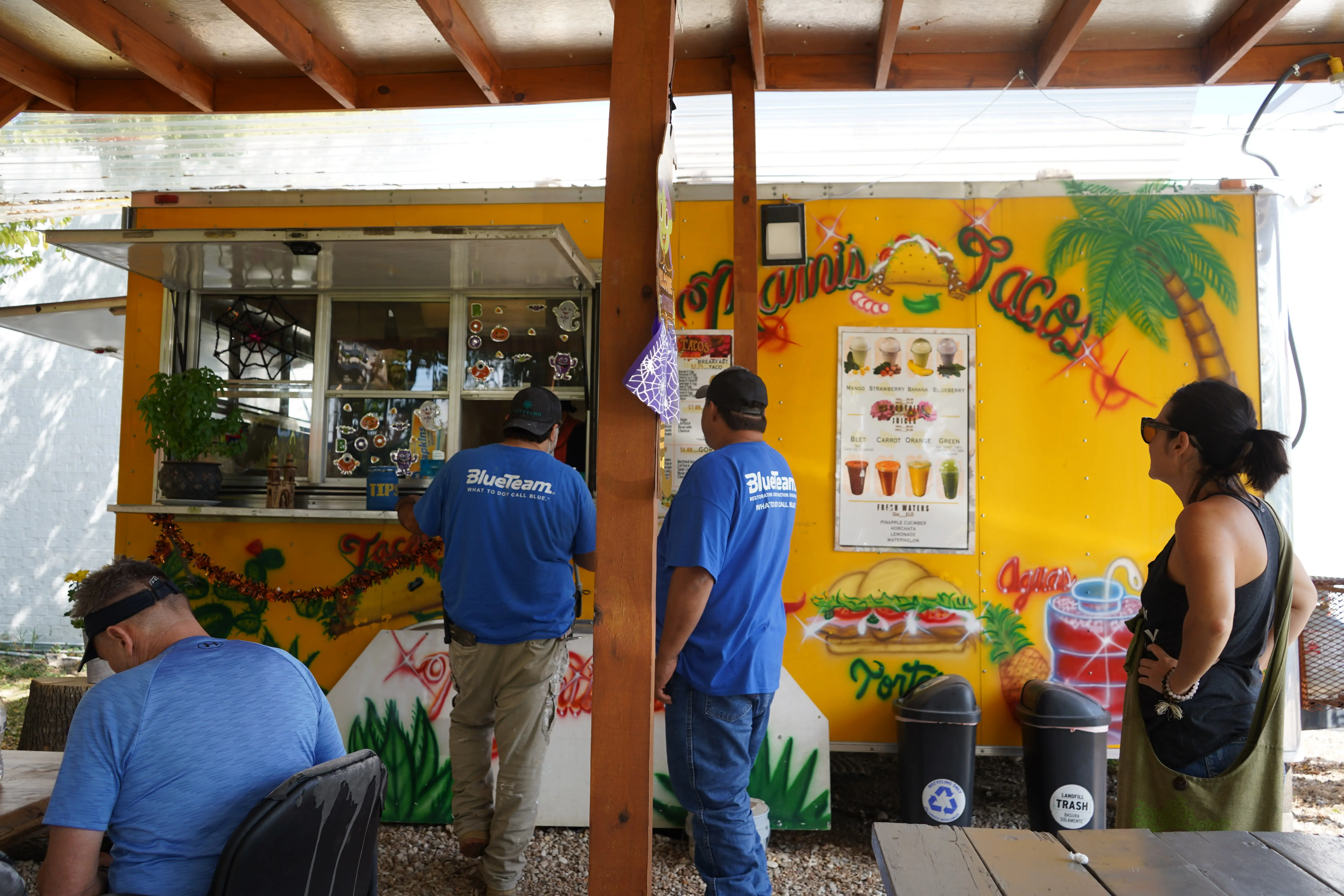 People ordering tacos or waiting for their food.