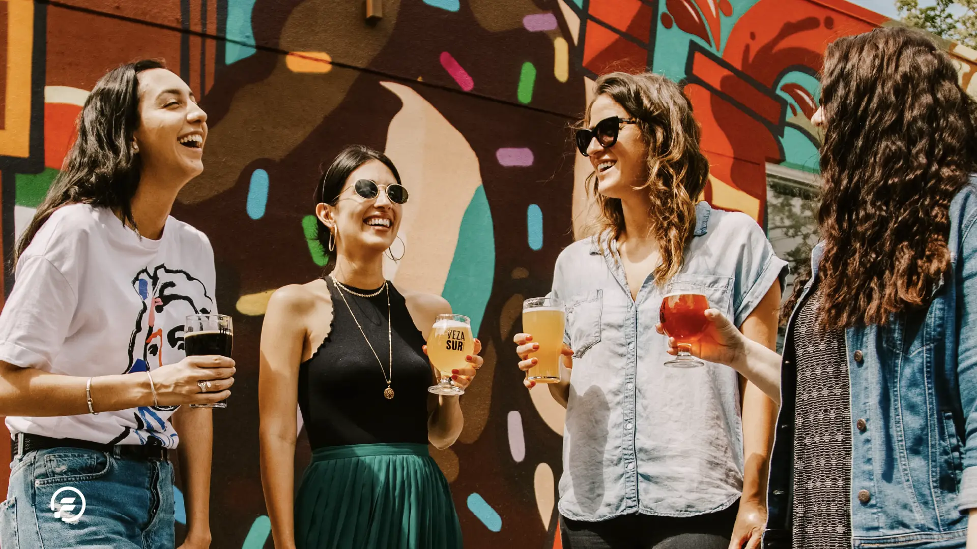 A group of ladies enjoying a cold beer, soaking in the sun and music.