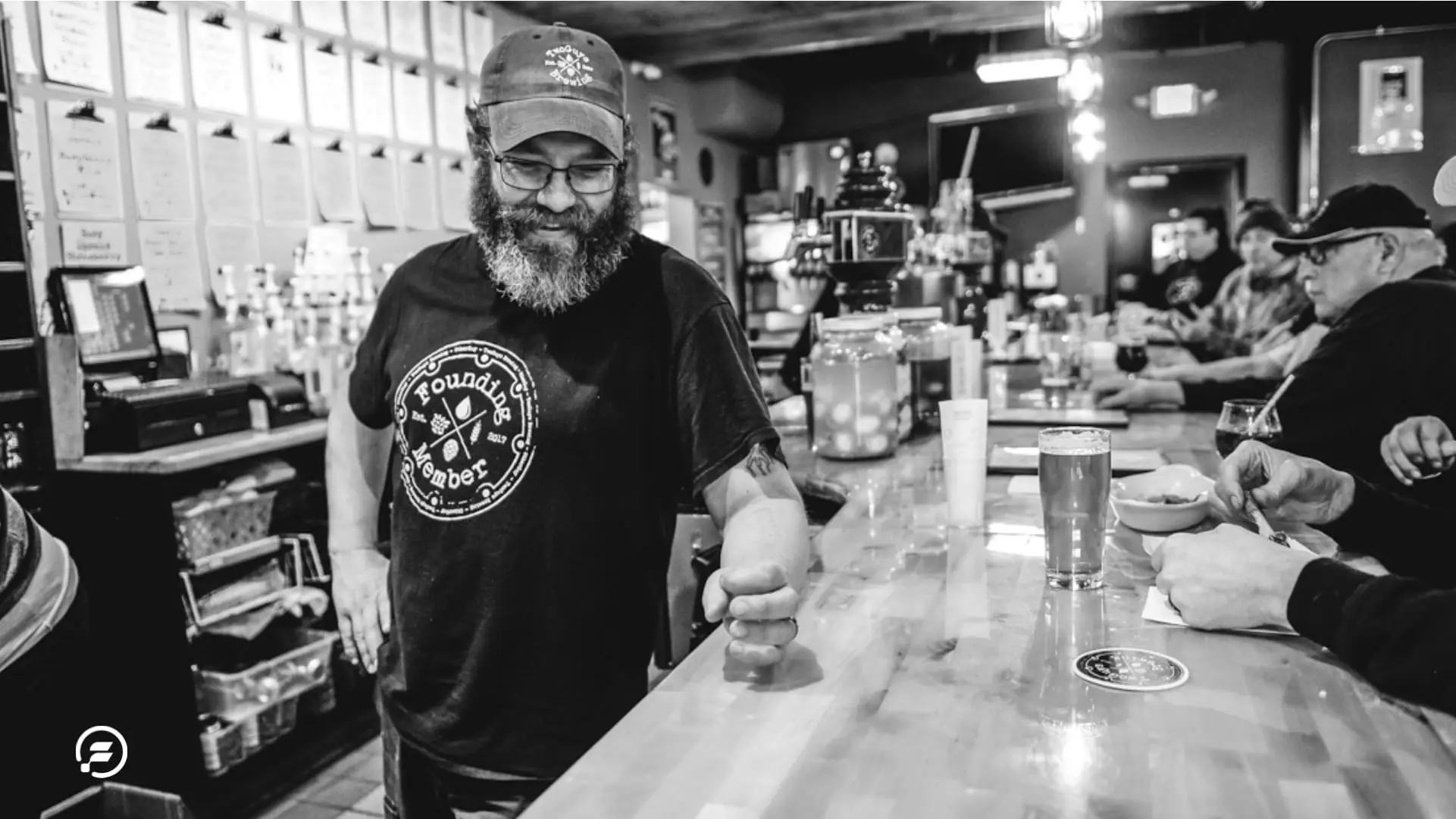 The Two Guys Brewing Owner smiling at the bar.