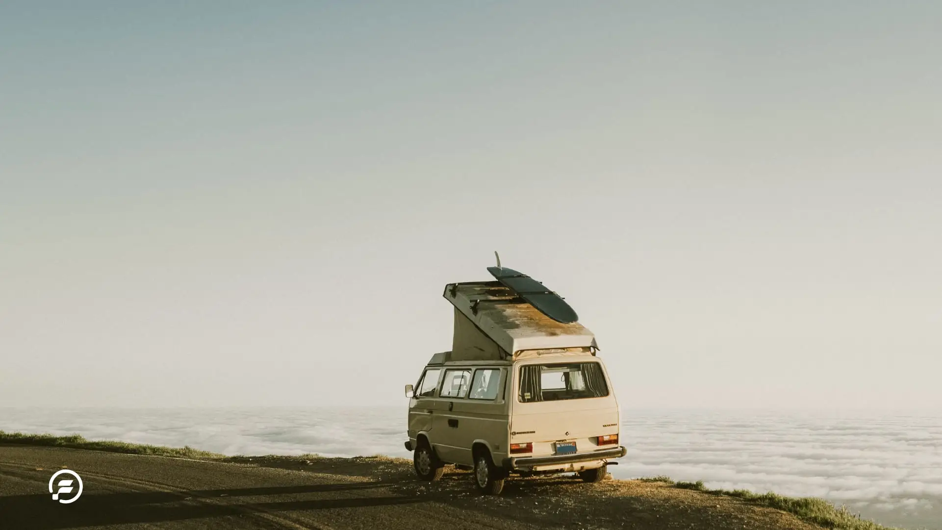 A van at the top of a cliff overlooking the ocean