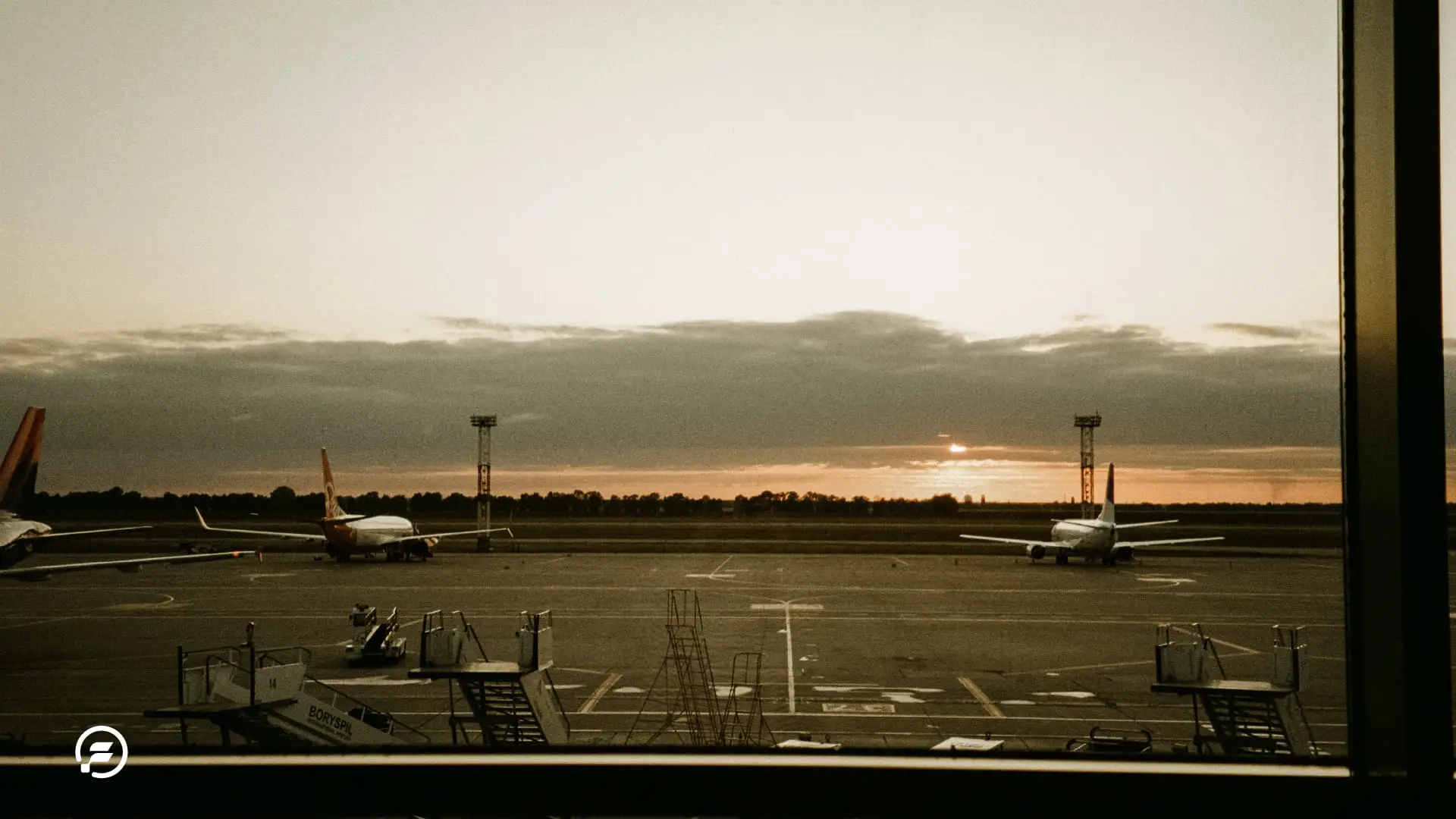 A beautiful sunset over the airport tarmac.