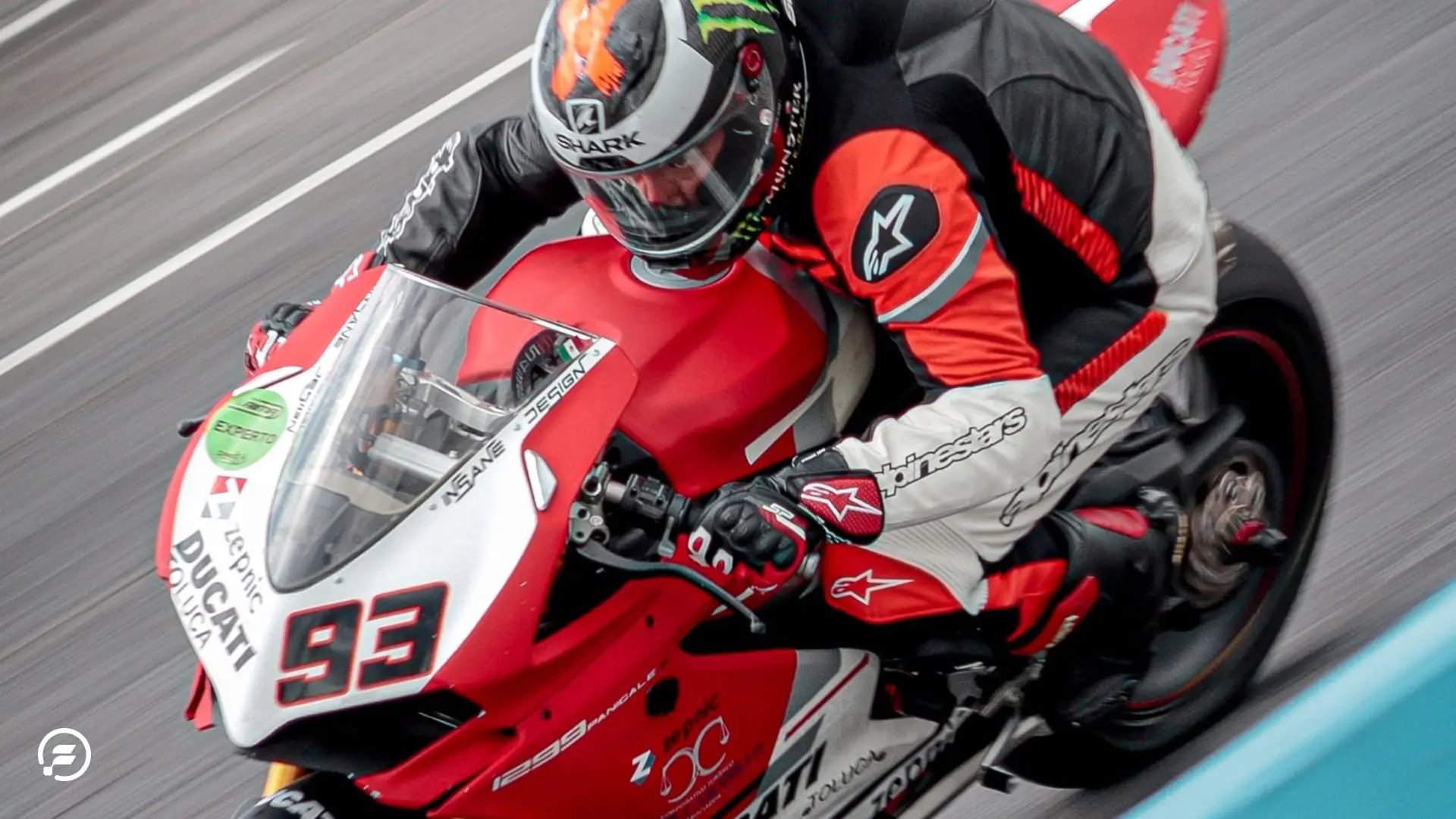 A MotoGP rider carving on the track.